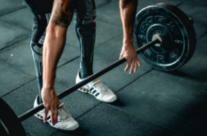 Man using barbell in gym