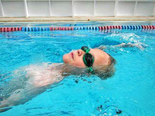 child swimming in lap pool