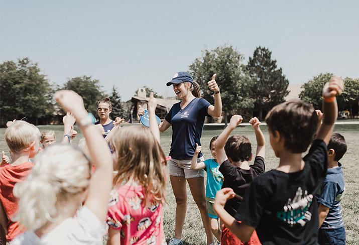 camp counselor with children at summer camp